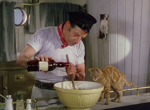 Laughing Anne - Nobby Ronald Shiner pouring liquor into bowl as marmalade tabby cat Ginger watches