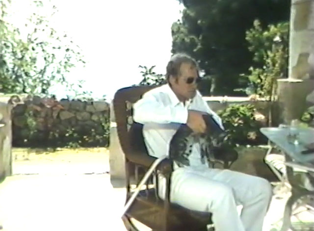 Laughter in the Dark - tabby cat being lifted from lap by More Nicol Williamson