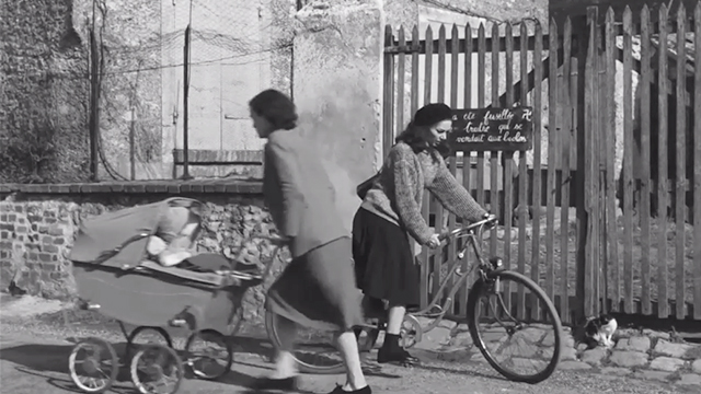 Léon Morin, Priest - Barny Emmanuelle Riva on bike and woman pushing pram outside gated home with black and white cat nearby