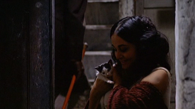 The Leopard - prostitute in doorway petting tuxedo kitten