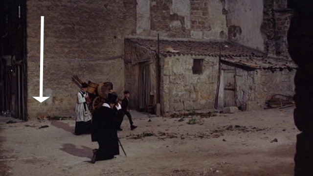 The Leopard - Prince Salina Burt Lancaster watching priest and boy walk down street past orange and white cat