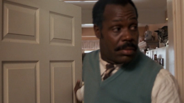 Lethal Weapon - tabby cat Burbank on top of refrigerator behind Murtaugh Danny Glover