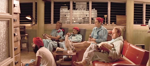 The Life Aquatic with Steve Zissou - Siamese cats on laps of men watching television