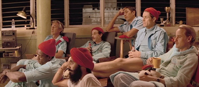 The Life Aquatic with Steve Zissou - Siamese cats on laps of men watching television