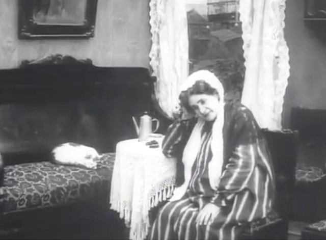 Little House in Kolomna - white cat with markings lying on couch in room with widow Praskovya Maksimova