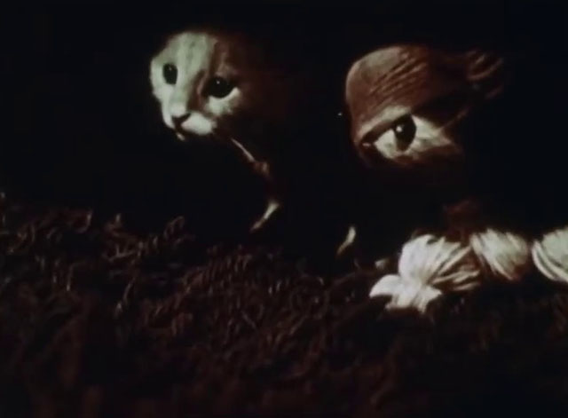 Little Kitten - white kitten with black markings hiding under sofa with twine cat puppet