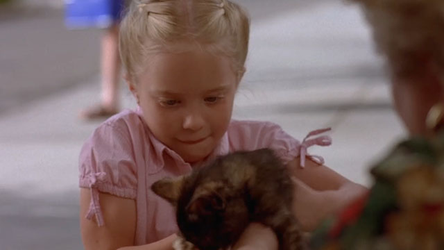 Little Secrets - Lea Danielle Chuchran being handed a tortoiseshell kitten
