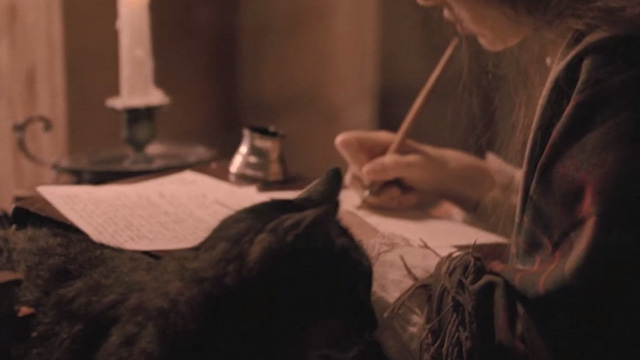 Little Women - tabby cat sitting next to Jo Winona Ryder as she writes