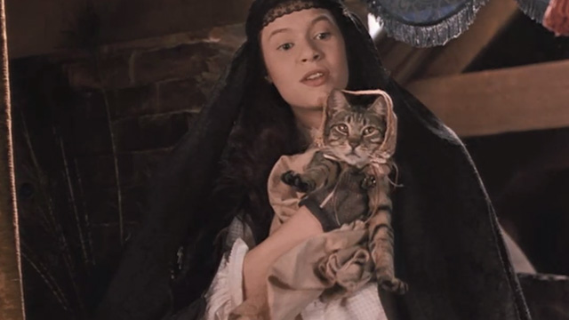 Little Women - Meg Trini Alvarado holding up tabby cat in bonnet