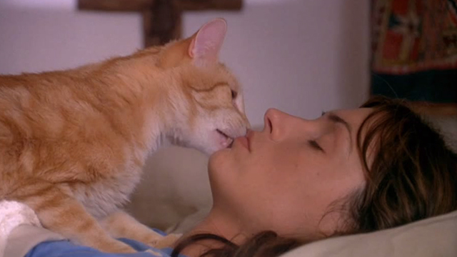 Love & Sex - Kate Famke Janssen being licked on chin by orange tabby cat
