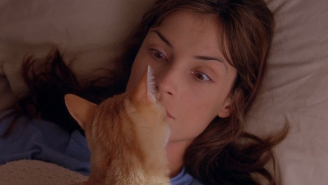 Love & Sex - Kate Famke Janssen opening eyes to see orange tabby cat licking her chin