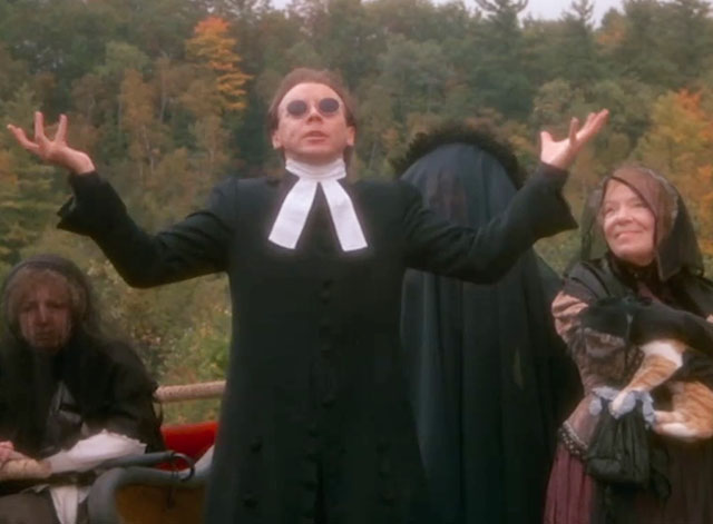 Love at Stake - Aunt Deliverence Norma MacMillan holding ginger and white tabby cat in mourning dress and veil with Parson Bud Cort