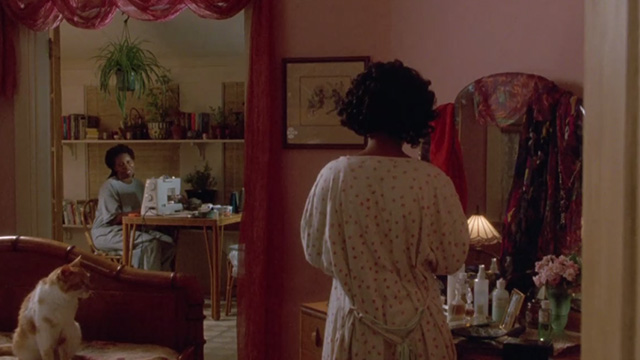 Made in America - orange and white cat sitting on bed with Sarah Whoopi Goldberg in background as Zora Nia Long enters