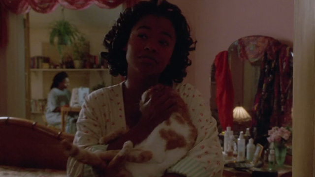 Made in America - Zora Nia Long holding orange and white cat as she exits from room with Sarah Whoopi Goldberg in background