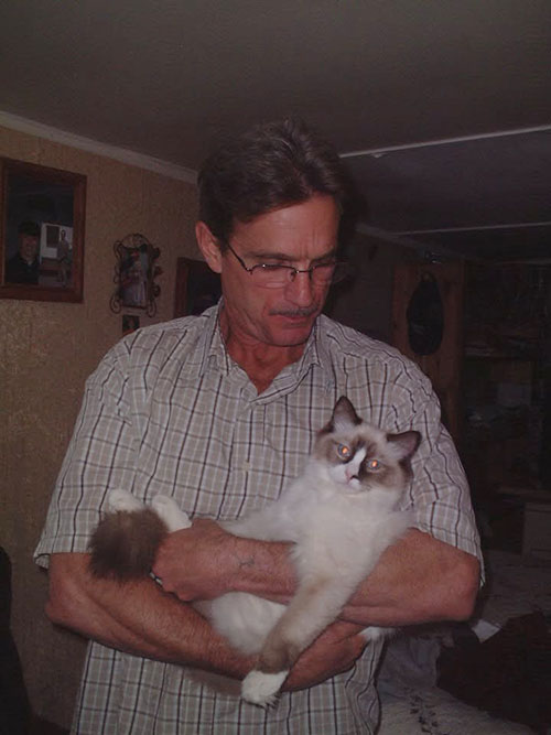 The Maiden Heist - Linda Honeysette's husband holding Ragdoll cat Twinkletoes