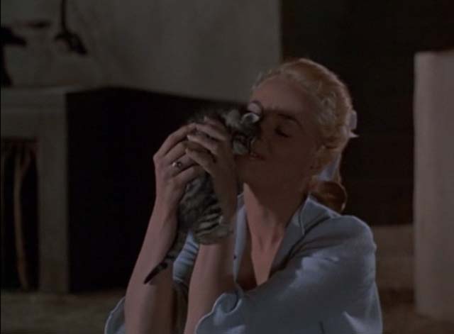 A Man Alone - Madine Mary Murphy pressing lighter tabby kitten to her face