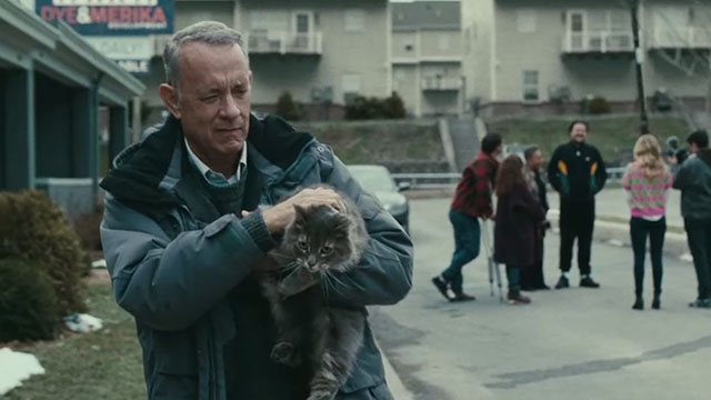A Man Called Otto - Otto Tom Hanks carrying longhair tabby cat Schmagel away from group