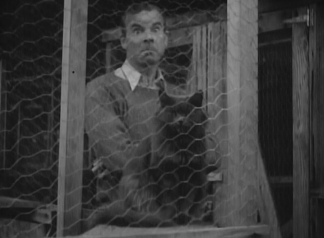 Maniac - rube neighbor behind cat in cage