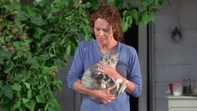 A Map of the World - silver tabby cat being taken outside by Alice Sigourney Weaver