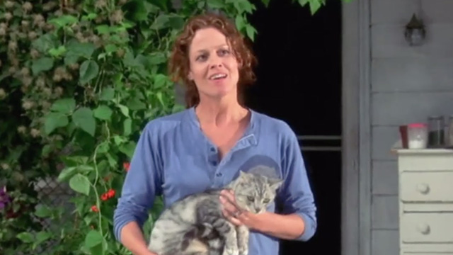A Map of the World - silver tabby cat being held outside by Alice Sigourney Weaver