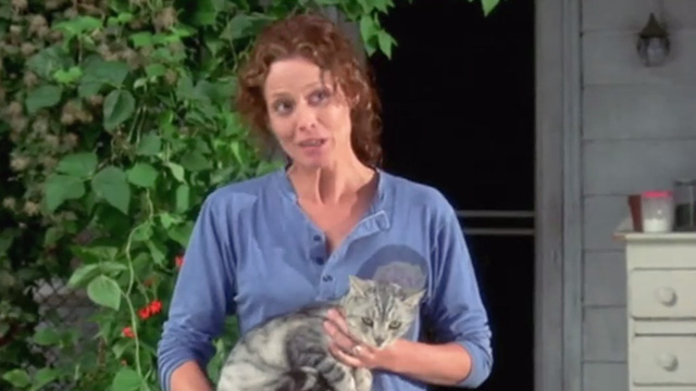 A Map of the World - silver tabby cat being held outside by Alice Sigourney Weaver
