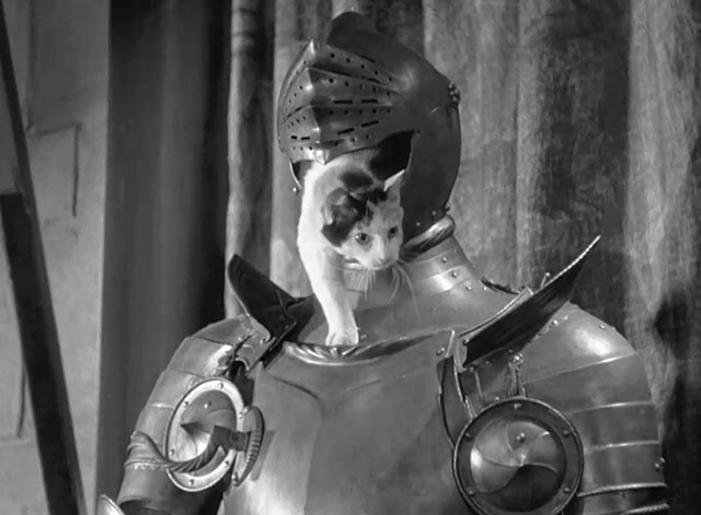 Mark of the Vampire - calico cat poking head out of visor on suit of armor