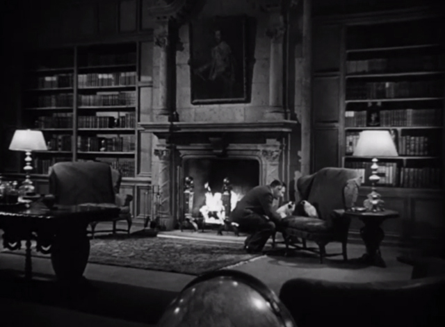 The Mask of Dimitrios - Cornelius Leydon Peter Lorre stooping down to pet two Siamese cats Eloisa and Abelard on divan