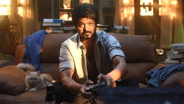 Master - cream Persian cat sitting on couch beside JD Thalapathy Vijay playing video games
