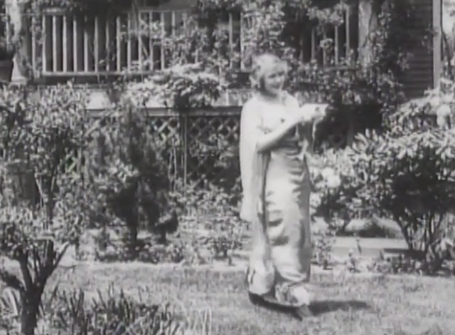 Matrimony's Speed Limit - Marian Swayne walking through garden holding small white cat