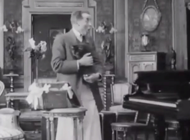 Max Doesn't Like Cats - butler Georges Gorby holding longhair tabby cat
