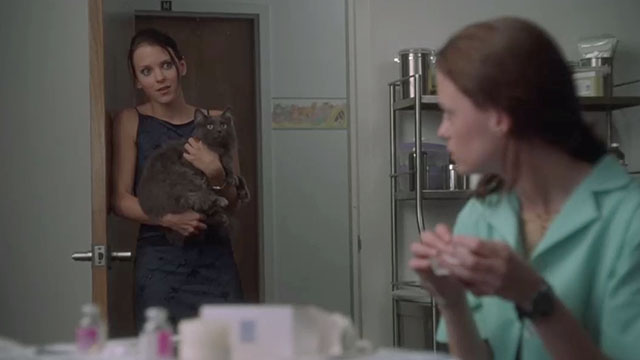 May - Polly Anna Farris holding longhair grey cat Lupe with May Angela Bettis