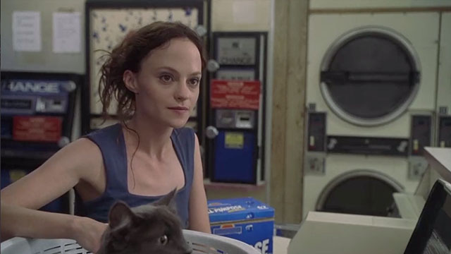 May - May Angela Bettis with longhair grey cat Lupe in laundromat