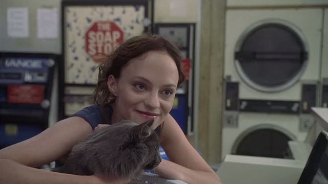 May - May Angela Bettis with longhair grey cat Lupe in laundromat