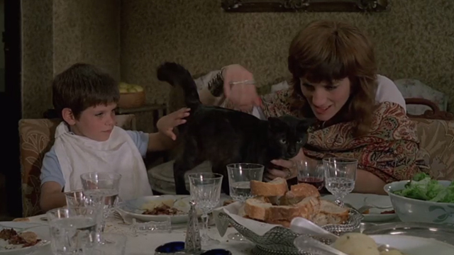 May Fools - Milou en Mai - black cat on table being petted by Lily Harriet Walter