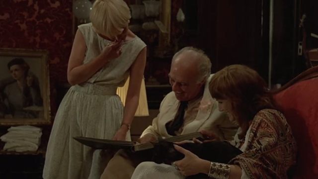 May Fools - Milou en Mai - black cat in lap of Lily Harriet Walter who is looking at photos with Milou Michel Piccoli