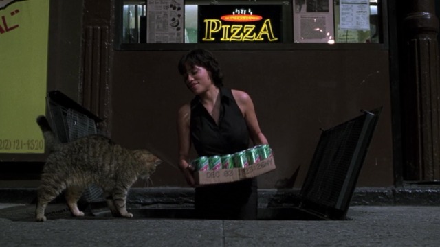 Men in Black II - tabby cat Bruno approaches Laura Rosario Dawson carrying case of soda