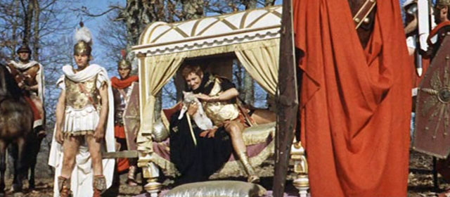 L'ultimo gladiatore - Messalina vs. the Son of Hercules - Caligula Charles Borromel sitting in lectica during battle with cream colored tabby cat