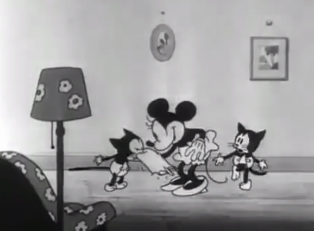 Mickey's Orphans - Minnie Mouse blowing kitten's nose with second kitten behind her holding legs together