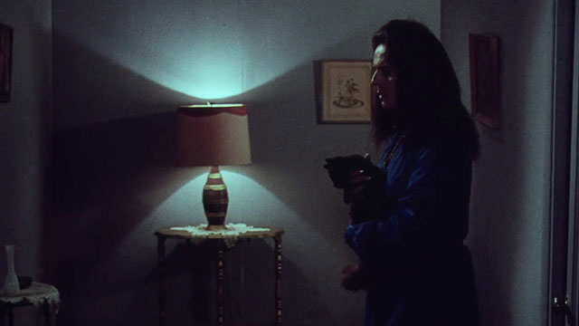 Miss Leslie's Dolls - Miss Leslie Salvador Ugarte holding black cat Tom in dark hallway