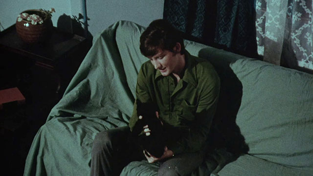 Miss Leslie's Dolls - Roy Chris Pitt holding black cat Tom on lap on covered couch