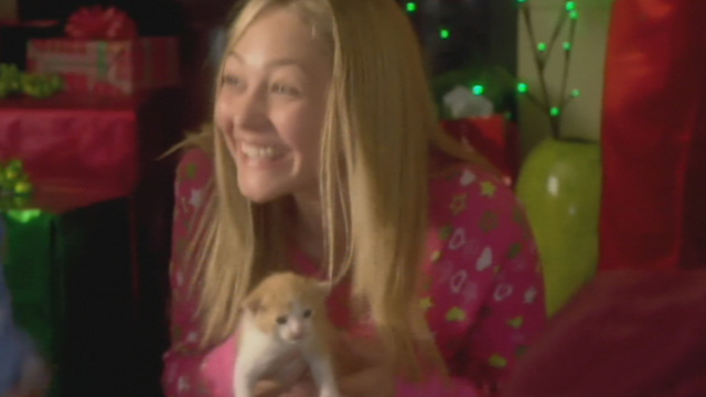 Mistletoe Over Manhattan - Bailey Olivia Scriven smiling over tiny orange and white kitten