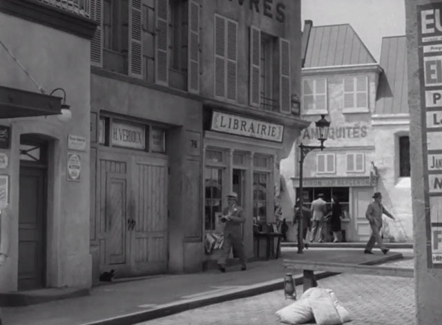 Monsieur Verdoux - Chaplin walking down Parisian street toward longhair tabby cat in doorway