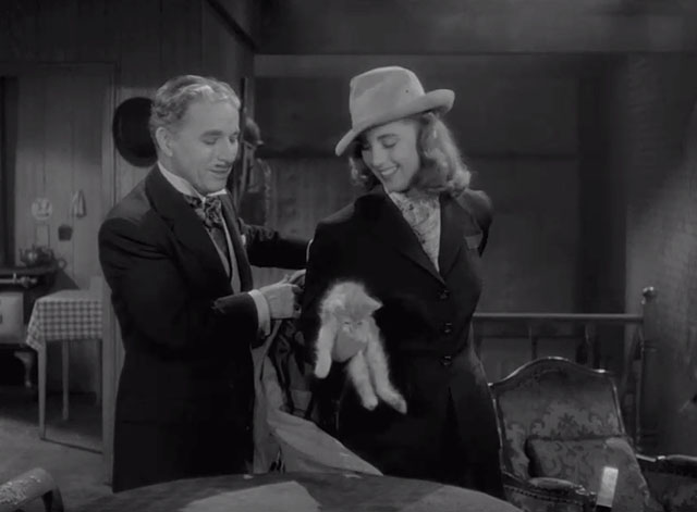 Monsieur Verdoux - Chaplin helping girl Marilyn Nash take off coat as she holds tabby kitten