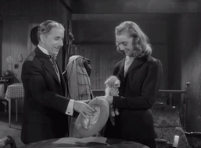 Monsieur Verdoux - Chaplin helping girl Marilyn Nash take off coat as she holds tabby kitten