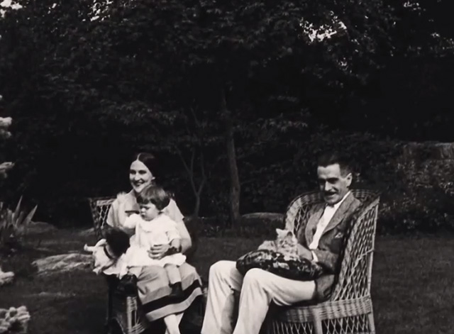 Motherhood: Life's Greatest Miracle - Mr. Sinclair J. Thomas Hopkins sitting with kitten on lap and Mrs. Sinclair Nance Newman with child