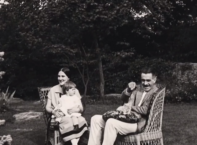 Motherhood: Life's Greatest Miracle - Mr. Sinclair J. Thomas Hopkins sitting with kitten on lap and Mrs. Sinclair Nance Newman with child