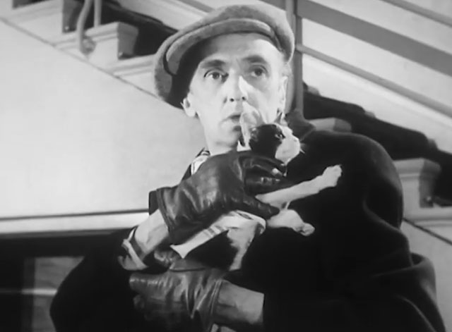 Mr. Beamish Goes South - Potter John Laurie holding black and white tuxedo kitten in coat