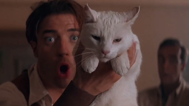 The Mummy - Rick Brendan Fraser holding up white cat