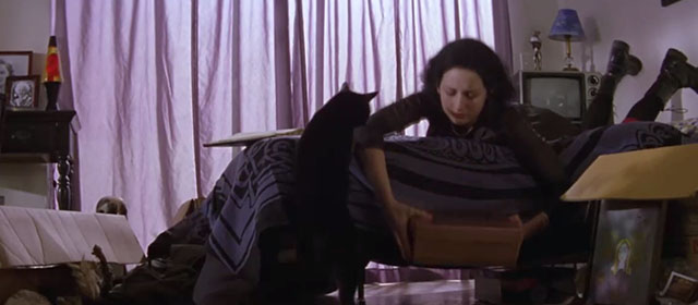 My First Mister - Black cat next to Jennifer Leelee Sobieski lying on bed