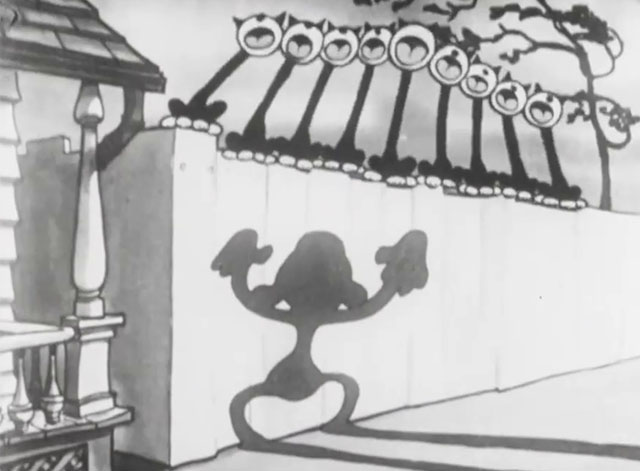 Mysterious Mose - cartoon black cats yowling on fence above shadow